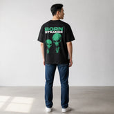 vvicked Born Strange black oversized cotton t-shirt with green alien graphic on the back worn by a man