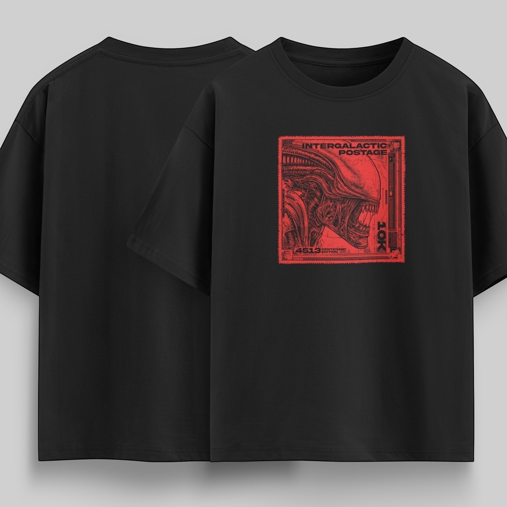 vvicked Intergalactic Postage oversized black cotton t-shirt featuring a red alien stamp graphic on the chest.